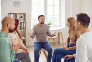 Group therapy session of adults who have dealt with substance abuse issues.